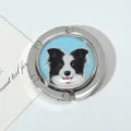 Macro detail of a silver foldable metal purse hook featuring a cute Border Collie dog print - Blue Border Collie Style