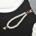 Detailed view of elegant white faux pearl keychain with a gold-plated letter I pendant - Letter Y(Y)