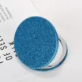 Portable circular blue glitter folding makeup mirror with double-sided design and metal frame - Diameter 60mm / Blue