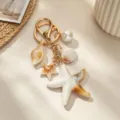 Close-up of ocean-themed keychain with starfish, seashell, conch and pearl charms - Large Starfish Seashell Keychain
