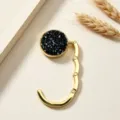 Close-up of a portable foldable gold metal handbag hook with a sparkling black inlay deco - Rhinestone Iridescent Black (镶钻挂包钩) / Black Style (镶钻挂包钩)