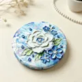 Detailed macro view showing the 3D relief oil painting floral texture on a round mirror - Oil Painting Flowers - Blue Rose
