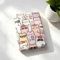 Close-up of a portable folding makeup mirror featuring cute cartoon cat illustrations - Milk Tea Sunglasses Cat