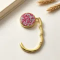 Detailed macro view of the sparkling pink rhinestone surface of the golden bag hook - Double Layer Rose Red Rhinestone (镶钻挂包钩) / Rose Red Style (镶钻挂包钩)