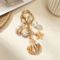 Close-up detail of ocean-themed keychain with brown sea shells and starfish charms - Large Scallop Seashell Keychain