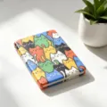 Close-up detail view of a compact folding mirror with colorful cartoon cat pattern - Colorful Contrast Cats