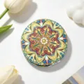 Detail view of a vintage ethnic style folding makeup mirror with mandala pattern - Amber Gold