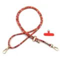 Close-up of colorful woven phone lanyard with gold metal hooks and red patch - Gold Buckle / Reddish Orange