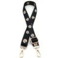 Detalle de la correa de repuesto negra con estampado de margaritas y herrajes dorados - N.º 3 Floral Negro, Blanco y Naranja