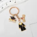 Detailed view of graduation themed keychain featuring academic gown and cap charms for students - Gown with Separate Scroll (Style 2)