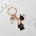 Close-up detail of academic gown, graduation cap, and tulip charms on a gold keychain - Gown with Red Tulip (Style 1)