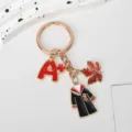 Close-up of graduation gown keychain featuring red A plus charm and maple leaf detail - Gown with A+ Mark (Style 2)