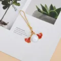 Detailed shot of alloy ginkgo leaf phone charm with iridescent pearl bead pendant - Pearl Ginkgo Leaf