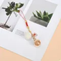 Close-up of a cute fox charm with a white pompom on a stylish red cord phone strap - Pom-pom Hollow Ball Fox 2