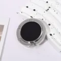 Close-up of a portable silver folding bag hook with a sleek black circular center - Single Hook Folding Style / Black