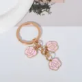 Elegant gold-tone keychain with three delicate pink enamel rose flower charms design - Pink