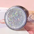 Close-up of portable round folding mirror with silver heart quicksand glitter detail - Silver