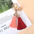 Close-up detail of golden bell and dual tassels in pink and burgundy red - Dark Red And Pink