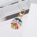 Colorful enamel monstera leaf keychain accessory with a gold lobster clasp for bags - Rainbow