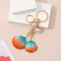 Creative resin seashell keychain with gradient orange blue colors and a white pearl charm - Seashell Keychain / Orange