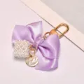 Purple satin ribbon bow keychain with artificial pearl cube and gold charm pendant - Light Purple