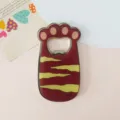 Detailed view of the cute cat paw metal fridge magnet with a smooth enamel finish. - Yellow Tiger Stripe