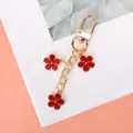 Charming alloy keychain featuring three red enamel flowers on a gold-plated chain. - Red G-clasp With Chain