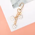 Elegant white enamel flower keychain featuring a durable gold-plated alloy lobster clasp - White G-clasp With Chain
