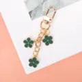 Elegant golden keychain with three green enamel flower charms for stylish bags and keys - Green G-clasp With Chain