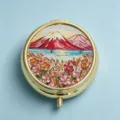 Macro view of the intricate Fuji mountain embroidery on a luxury golden round pill box lid - Round Mount Fuji Flower Landscape / 2 Compartments / Gold