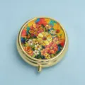 Detailed view of a round gold pill box with vibrant floral relief pattern design - Blazing Gold Flower Cluster (Round Gold Frame)