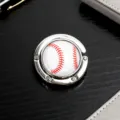 Detailansicht eines tragbaren faltbaren Taschenhakens aus Metall mit Baseball-Design - Baseball