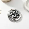Macro view of portable bag hook with stylish black and white heart checkerboard - Heart Pattern / Silver
