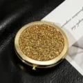 High-quality close-up of a gold round makeup mirror featuring sparkling glitter finish - 70mm / Champagne gold diamond (gold frame)