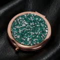Close-up of glitter and stud detail on rose gold round folding makeup mirror - 70mm / Sapphire blue (rose gold)