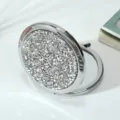 Close-up of sparkling rhinestone-covered foldable metal compact makeup mirror - 70mm / Flashing silver diamond (silver frame)