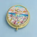Elegant round golden metal pill box featuring a colorful rabbit and moon embossed lid design - Seaside Starry Flower Sea (Round Gold Frame)