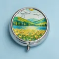 Compact round silver pillbox featuring a vibrant landscape mountain and lake art design - Golden Mountain Flower Field (Round Silver Frame)