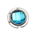 Detailed view of a foldable circular metal purse hook with a faceted blue gemstone. - 4.50cm / Light Blue (Rhinestone Style)