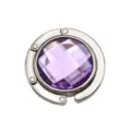 Detailed view of portable folding metal bag hook with a purple faceted gemstone. - 4.50cm / Light Purple (Rhinestone Style)