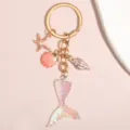 Porte-clés queue de sirène irisée avec breloques étoile de mer et coquillages dorés. - Dégradé Irisé (Style 01)