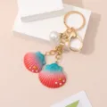 Elegant resin shell keychain featuring a pink-teal gradient design and a white pearl charm - Seashell Keychain / Watermelon red