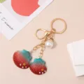 Creative seashell keychain with teal and red gradient finish and faux pearl charm - Seashell Keychain / Red