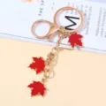 Elegant gold-plated keychain featuring three red enamel maple leaf charms for bags and keys - Red Style