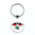 Detail view of Palestine flag keychain featuring a bird graphic and brotherly slogan - Eagle Emblem Style / Epoxy Style