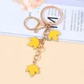 Elegant golden metal keychain featuring three vibrant yellow maple leaf charms for bags. - Yellow Style