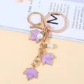 Elegant purple maple leaf keychain with pearls in rose gold finish metal - Purple Pearl Style