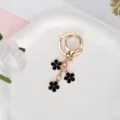 Elegant golden keychain featuring three black enamel flower charms for bags or keys - Black With Lobster Clasp