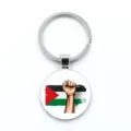 Silver Palestine flag keychain pendant with circular glass dome and fist graphic design - Fist Gesture Style / Epoxy Style