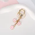 Elegant gold-tone metal keychain featuring three delicate pink enamel flower charms - Pink With Lobster Clasp